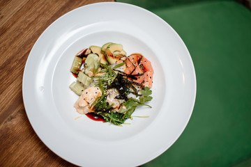 fresh salmon salad on white plate hommemade food