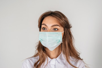 Young adult nurse portrait, with protective medical mask