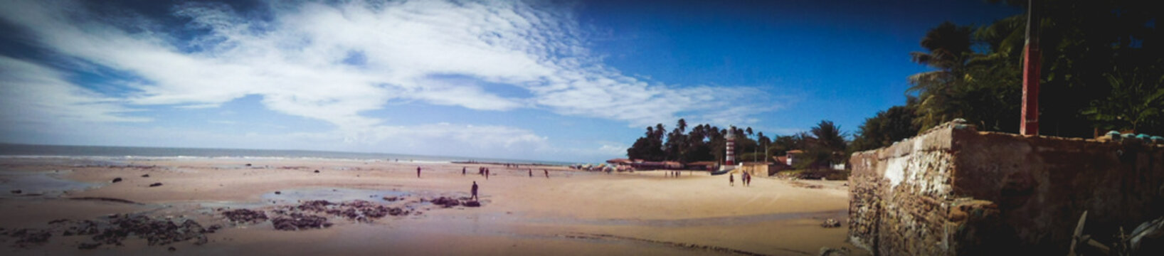 Panoramic view of a lighthouse red and white in Farol de Paracuru, Ceara Brazil