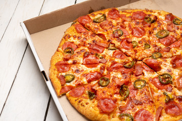 Mexican pizza with jalapeno pepper and bacon on white background