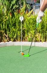 Playing Miniature Golf with Protective Gloves