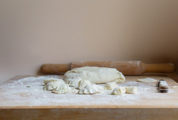 rolling pin for dough on a wooden table. home baking pies, pizza, pasta on the background of a wooden table. Concept of cooking at home
