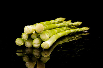 Healthy vegetable asparagus isolated on black