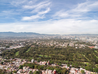 Fototapeta na wymiar Aerial panoramic view of a Golf Course in Mexico City with a blue sky as background