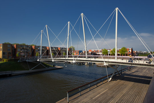 Almere, Netherlands - April 22 2019: Pedestrian bridge over a canal