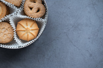 Traditional butter cookies from Denmark in a box on concrete background. Top view. Close up view. Copy space.