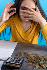 The poor young girl is worried by the small amount of money because she knows that it is not enough for all bills.