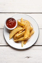French fries with ketchup sauce on white background