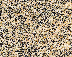 abstract background of fried sesame seeds and caraway seeds
