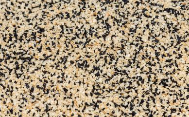 abstract background of fried sesame seeds and caraway seeds