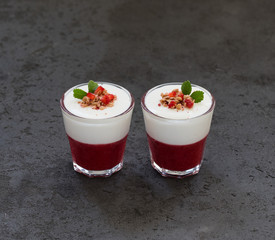 Italian dessert Panna cotta vanilla with strawberries in a glass on a dark background