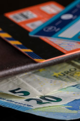 Euro cash money bills sticking out of a wallet and on top a couple of bank credit cards
