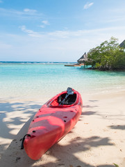 red kayak on a caribbean beach