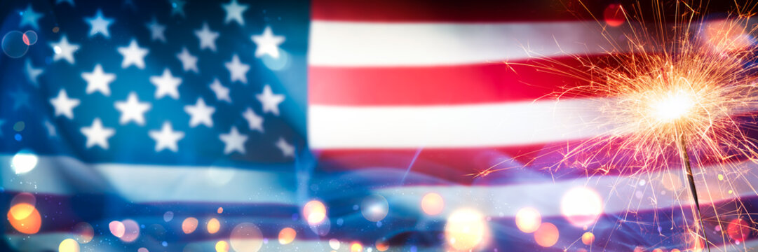 Close-up Of Sparkler With Bokeh And Smoke On American Flag Background - Independence Day Celebration Concept