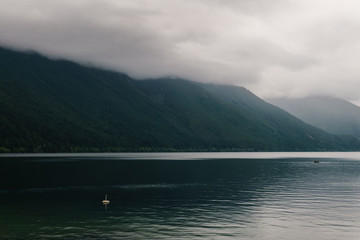 Beautiful Chilliwack lake green forest and cloudy sky british columbia canada.