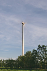 Wind turbine with fast moving propellers (long exposure photo)