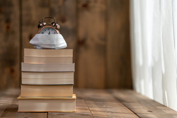 Books lined up on a wooden floor are the best activities to do at home while preventing the spread of the virus, the book protects us from everything. It's in the virus.