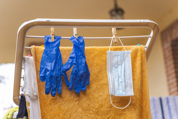 Medical gloves and surgical mask hanging on a clothesline