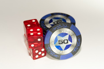 4 red casino dice and chips with a face value of 50 on a white background