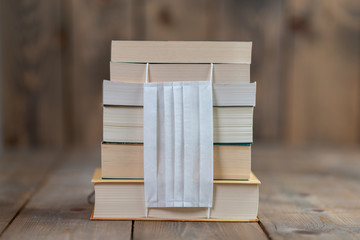 Books lined up on a wooden floor are the best activities to do at home while preventing the spread of the virus, the book protects us from everything. It's in the virus.