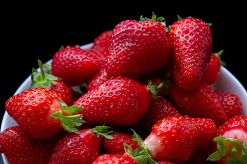 fresh juicy strawberry with the dark background close up