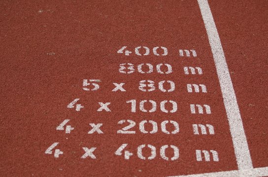 Closeup Of White Printed Numbers On Rubber Sports Track