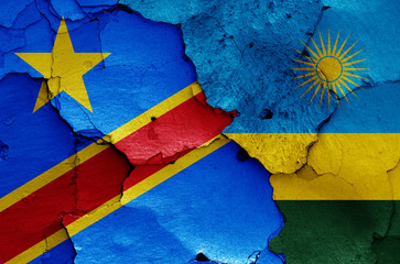 flags of DR Congo and Rwanda painted on cracked wall