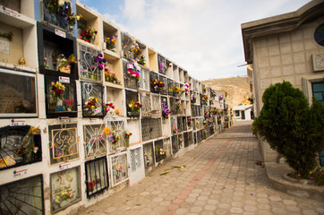 Fototapeta na wymiar QUITO, ECUADOR- MAY 23, 2017: View of cemetery San Antonio de Pichincha, showing typical catholic graves with a burial vaults