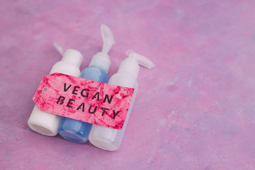 beauty products with no animal testing concept, group of moisturizers and toner lotions with Vegan Beauty message on label next to them