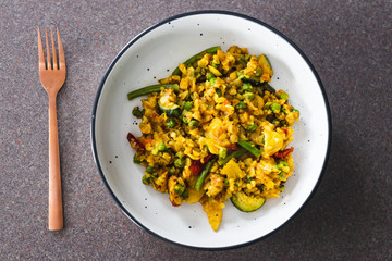 plant-based food, vegan turmeric and cumin potato scramble with mediterraneand veggies and peas