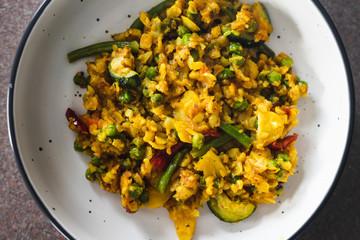 plant-based food, vegan turmeric and cumin potato scramble with mediterraneand veggies and peas