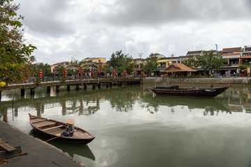 Fototapeta na wymiar Boats near the bridge in old town of Hoi An in Vietnam