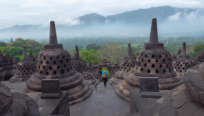 Tourist backpacker exploring the Borobudur temple in Java island, Indonesia