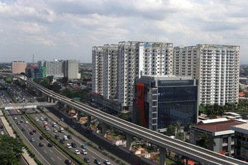 Fototapeta na wymiar traffic at MT. Haryono street Jakarta, Indonesia with office building