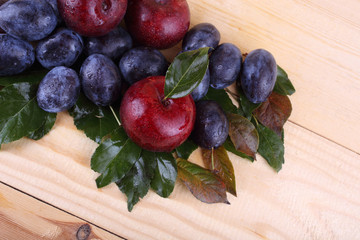 Different color plums on table