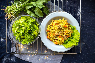 Yellow millet grain porridge with vegetables, herbs, spices and mushrooms. Vegan healthy food.