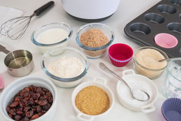 Bran muffins with dry cranberries recipe. Bran, flour, buttermilk, dry berries, and some other ingredients close up on a kitchen table