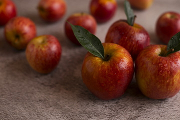  Red apples with leaves on a gray background