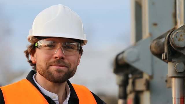 Portrait of smiling engineer wearing helmet