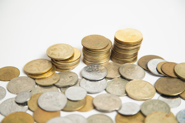 Coins stacked in small towers - Coins isolated from white background - Pile of queztales currency of Guatemala