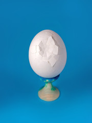 white broken egg on a stand on a white background