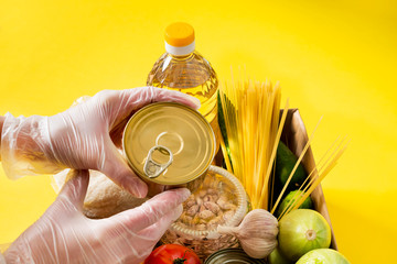 Donation. Food supplies crisis food stock for quarantine isolation period on yellow background....
