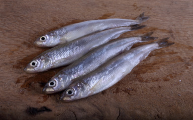 Smelt fish on cutting board
