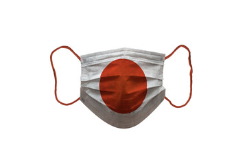 Surgery mask used for protections against coronavirus. Japan flag.