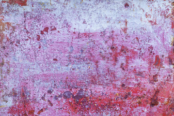 Multicolored background: rusty metal surface with flaking and cracking texture.