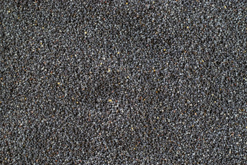Pile Poppy seeds texture dark background. Black poppyseed food pattern in top view. Vitamin snack breakfast, diet and healthy eating concept.