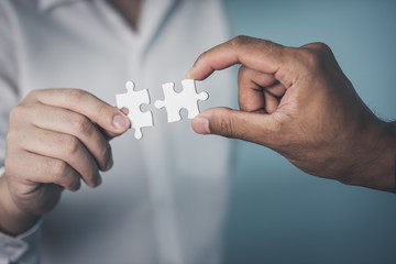 Businessman suffering to have a piece of jigsaw puzzle