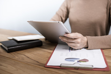 business woman working on white desk with laptop, pad, smartphone at office look very busy. work from home concept