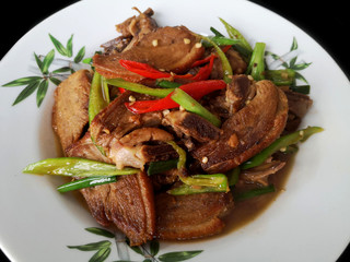 Duck meat stir fried with fresh chilies in a white plate