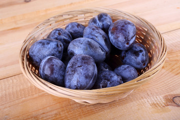 Black plums on table